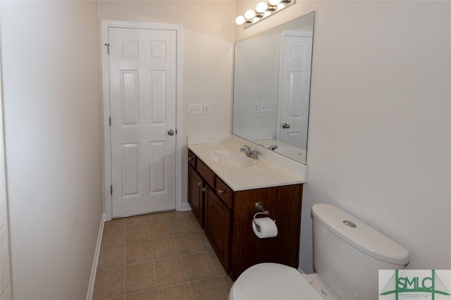 bathroom featuring vanity, toilet, and tile patterned floors