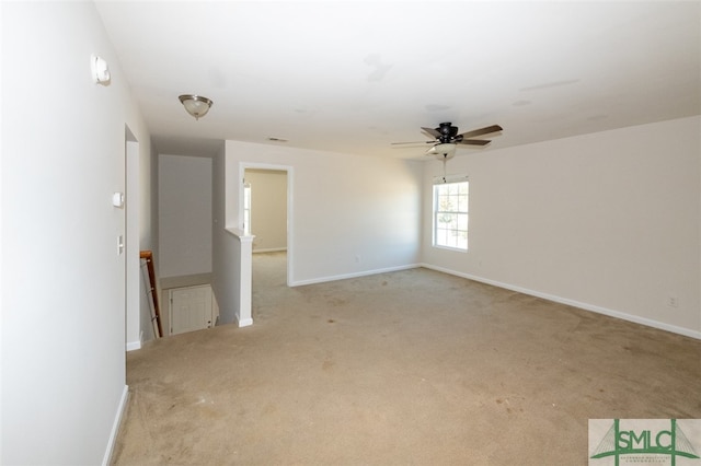 carpeted spare room with ceiling fan