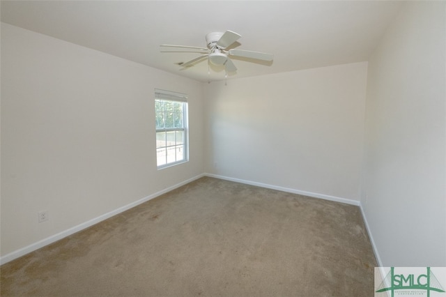 carpeted spare room with ceiling fan