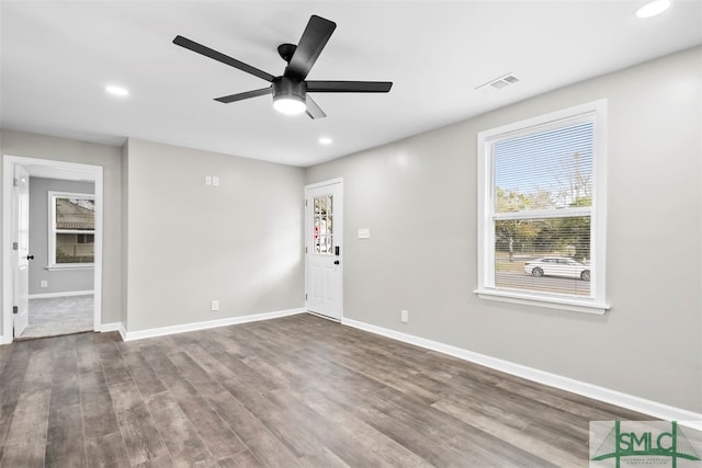 empty room with ceiling fan and hardwood / wood-style floors