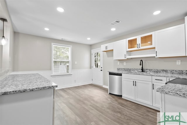 kitchen with pendant lighting, stainless steel dishwasher, and white cabinets