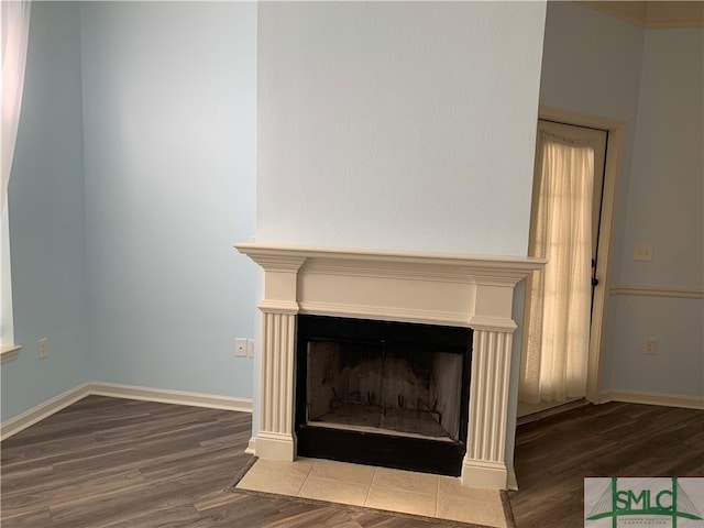 details featuring hardwood / wood-style flooring and a tile fireplace