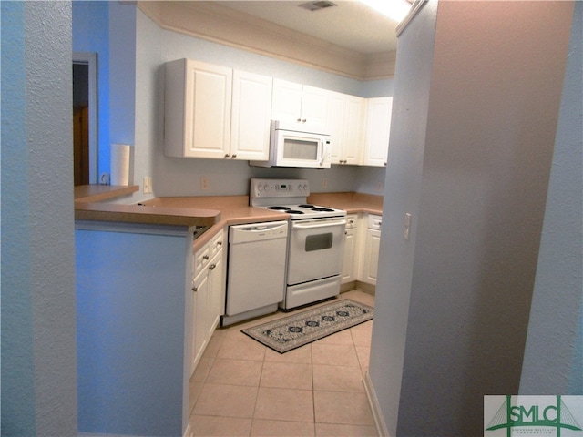 kitchen with white cabinetry, white appliances, and light tile patterned floors