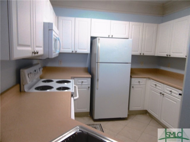 kitchen featuring white cabinetry and white appliances