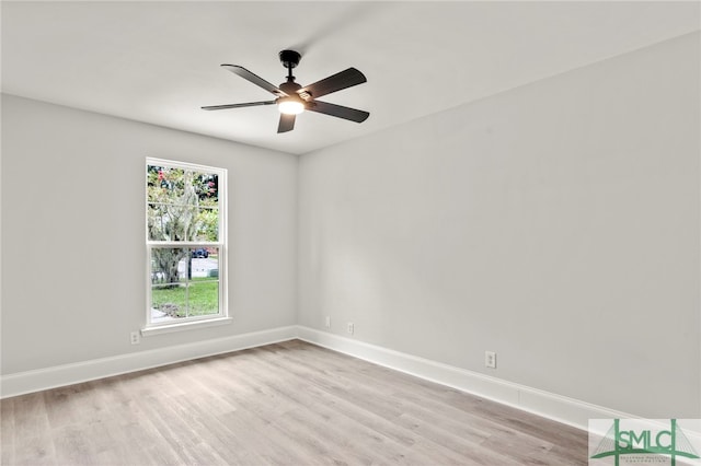 empty room with ceiling fan and light hardwood / wood-style flooring