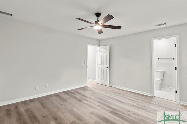 unfurnished bedroom with light wood-type flooring, ceiling fan, and ensuite bathroom