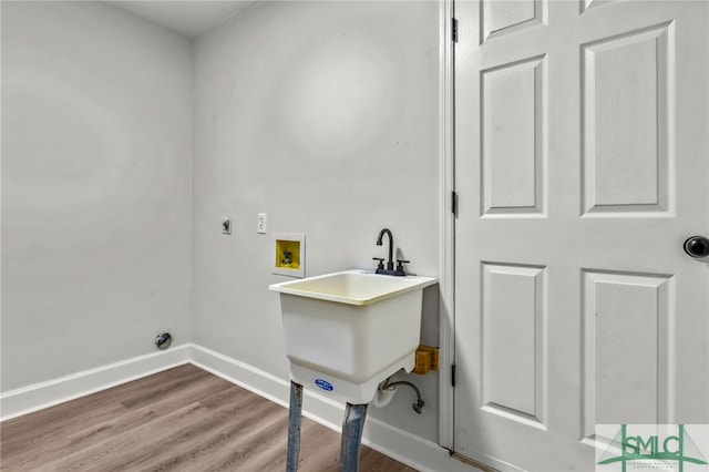 laundry area featuring hookup for a washing machine, hardwood / wood-style floors, and electric dryer hookup