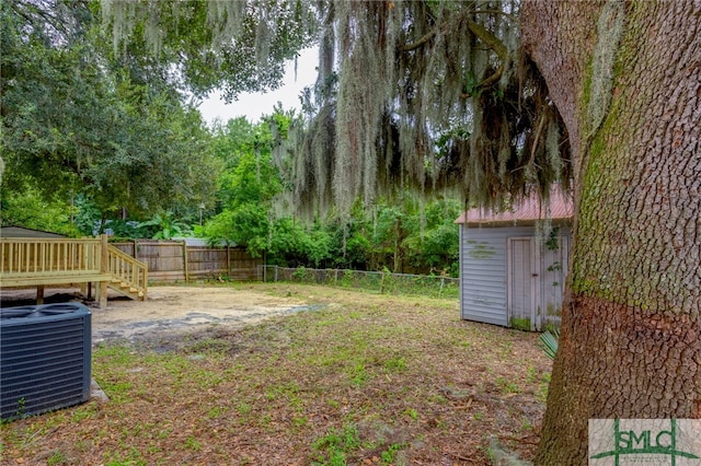 view of yard featuring a storage shed and central AC