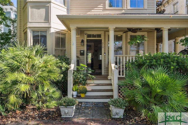 view of exterior entry with ceiling fan and covered porch