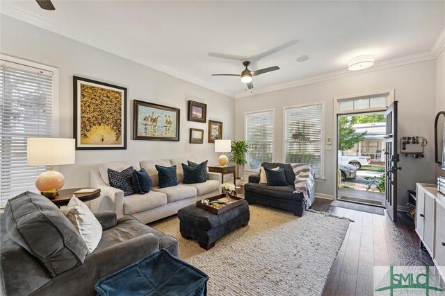 living room featuring wood-type flooring, ornamental molding, and ceiling fan