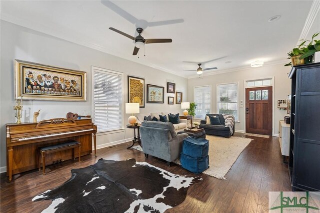 living room with ceiling fan, ornamental molding, and dark wood-type flooring