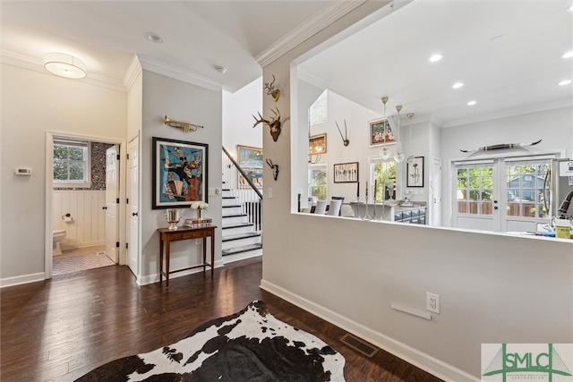 hallway featuring french doors, dark hardwood / wood-style floors, and crown molding