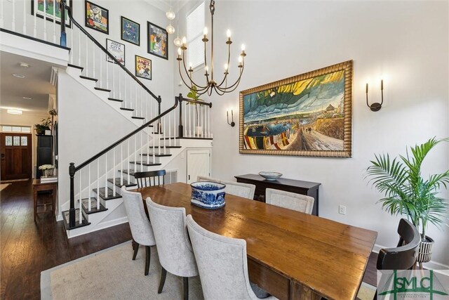 dining area with an inviting chandelier and dark wood-type flooring