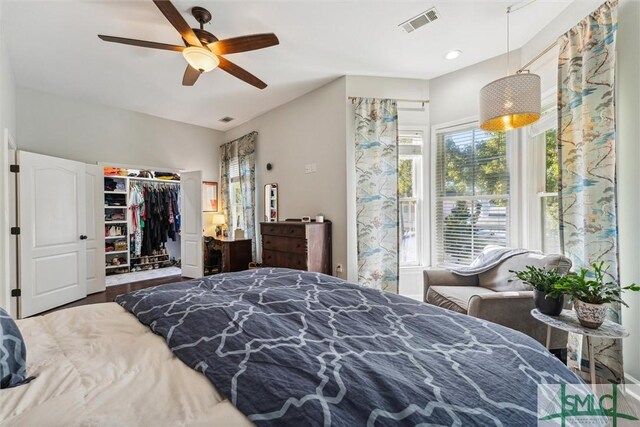 bedroom with a closet, hardwood / wood-style flooring, and ceiling fan