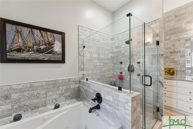 full bath featuring a stall shower and a whirlpool tub