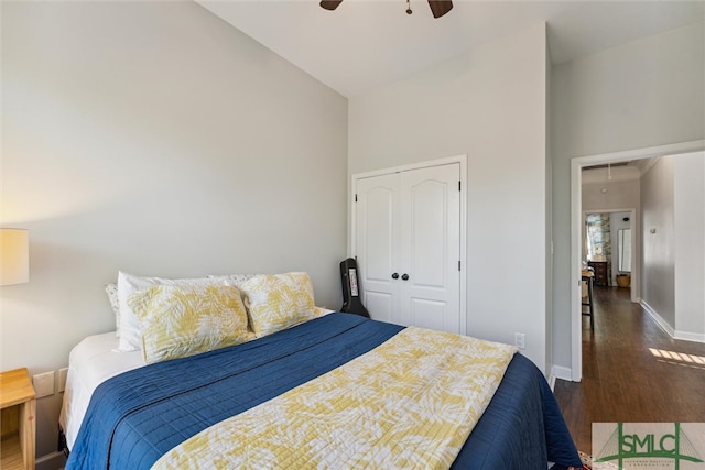 bedroom with ceiling fan, a closet, and dark hardwood / wood-style floors