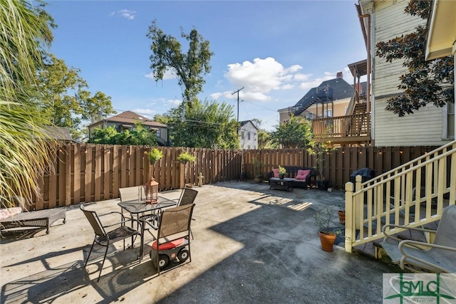 view of patio with outdoor dining area and a fenced backyard