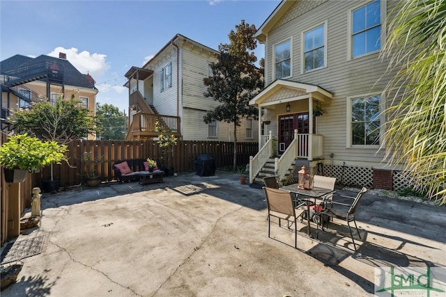 view of patio / terrace with entry steps, outdoor dining area, and fence