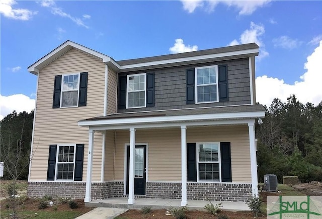 view of front of home with a porch and central AC unit