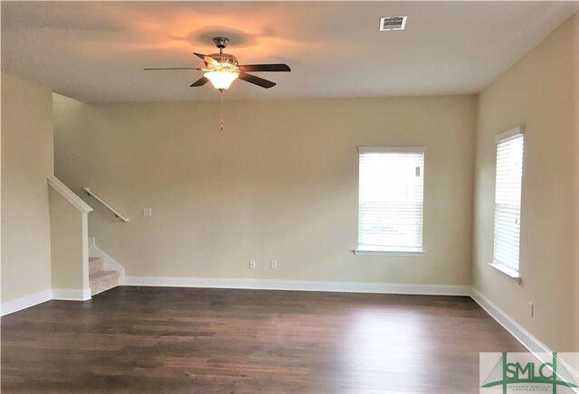 interior space featuring plenty of natural light, ceiling fan, and dark wood-type flooring