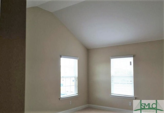 spare room featuring vaulted ceiling