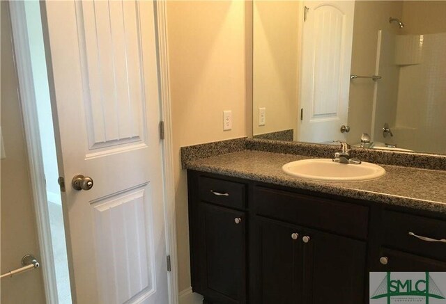 bathroom with shower / tub combination and vanity