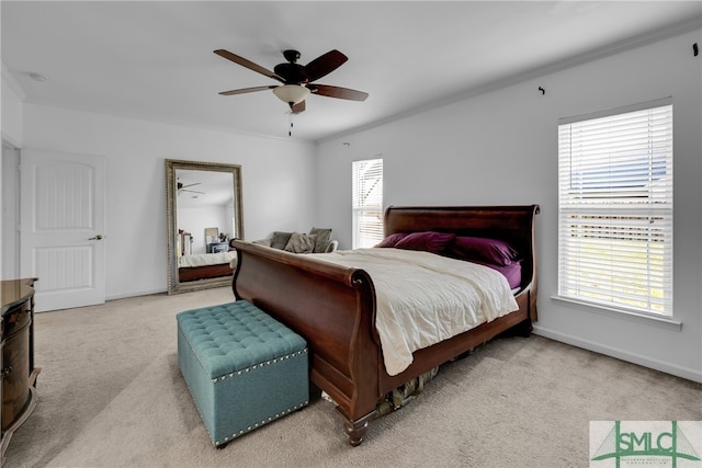 bedroom featuring light carpet, crown molding, and ceiling fan