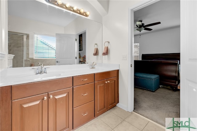 bathroom with vanity, a tile shower, ceiling fan, and tile patterned floors