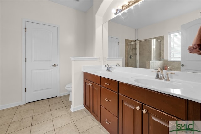 bathroom featuring vanity, toilet, an enclosed shower, and tile patterned floors