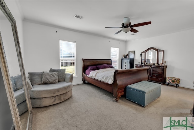 bedroom featuring ceiling fan, crown molding, and light carpet