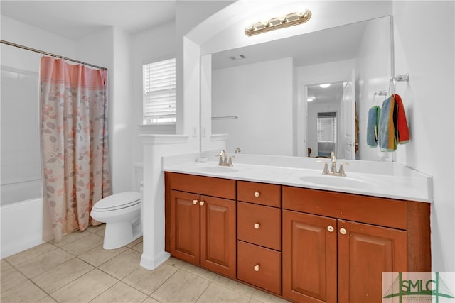 full bathroom with shower / bath combo with shower curtain, tile patterned flooring, toilet, and vanity