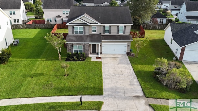 view of front of property featuring a garage and a front lawn