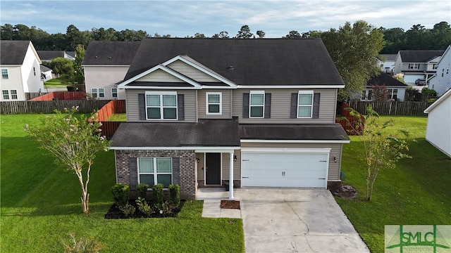 view of front of property featuring a front yard and a garage