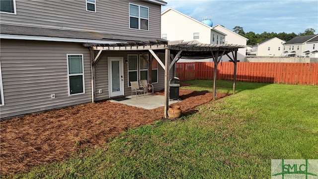 rear view of house with a pergola, a patio area, and a lawn