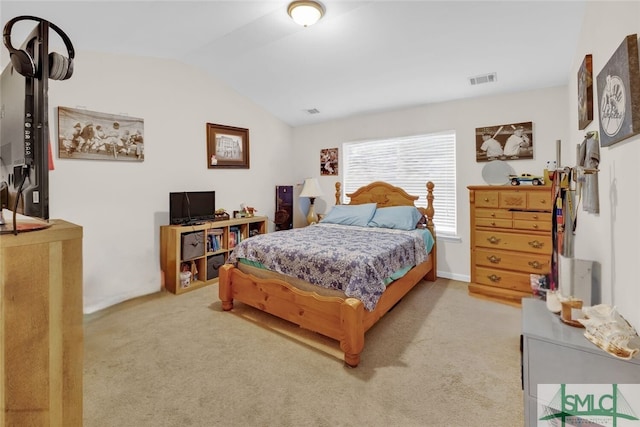 bedroom with lofted ceiling and light carpet