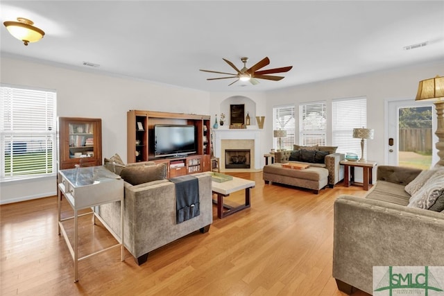 living room featuring ceiling fan and light hardwood / wood-style floors