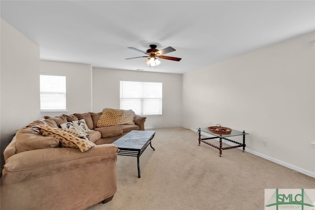 carpeted living room featuring a wealth of natural light and ceiling fan