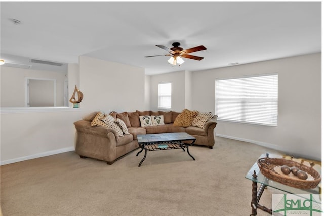 carpeted living room with ceiling fan