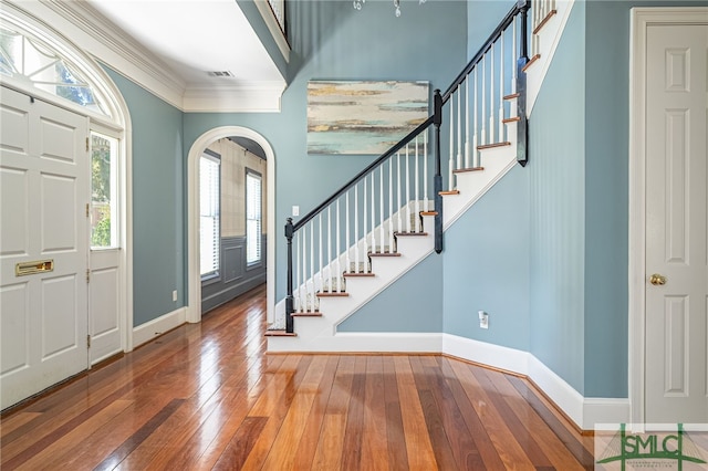 entryway with hardwood / wood-style flooring and ornamental molding