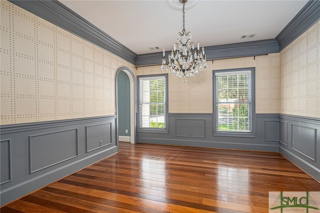 spare room with ornamental molding, dark hardwood / wood-style flooring, and a wealth of natural light