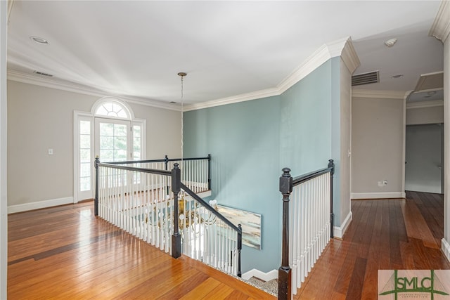 hallway with hardwood / wood-style flooring and ornamental molding