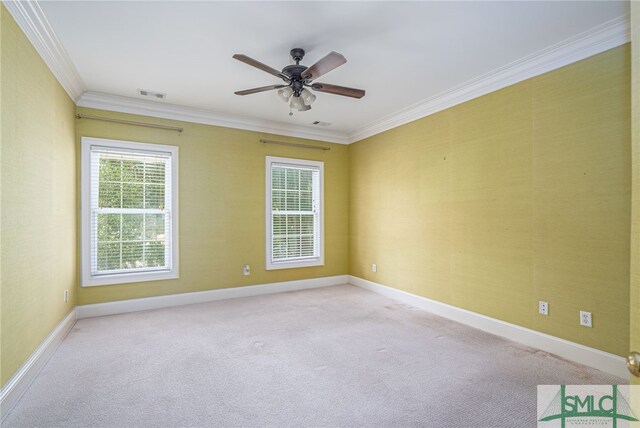 carpeted spare room with crown molding and ceiling fan