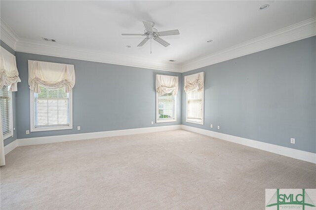 unfurnished room featuring ornamental molding, plenty of natural light, and ceiling fan