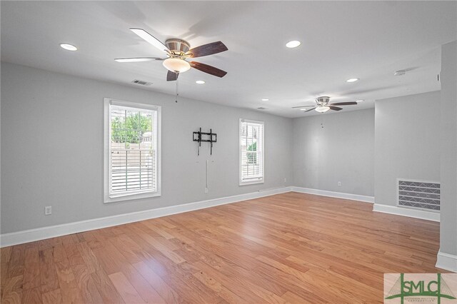 unfurnished room featuring light wood-type flooring and ceiling fan