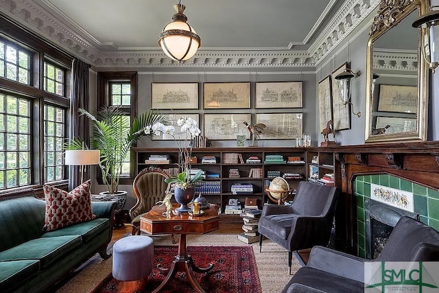 sitting room featuring ornamental molding, a wealth of natural light, and a tile fireplace