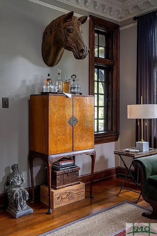 living area featuring hardwood / wood-style flooring and ornamental molding