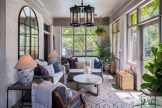 sunroom / solarium featuring a chandelier and wooden ceiling