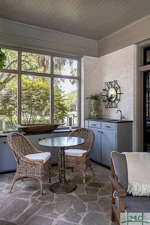 unfurnished sunroom featuring sink and wooden ceiling