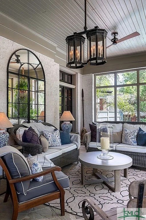 sunroom / solarium with a healthy amount of sunlight, ceiling fan, and wooden ceiling