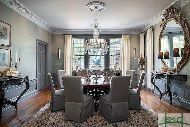 dining area with crown molding, dark wood-type flooring, and a notable chandelier